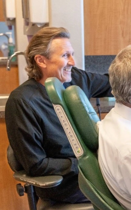 Dr. Futch sitting with a patient